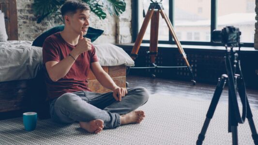 Young man recording video at home.